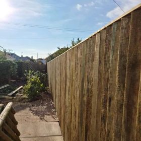 Dark wooden panel fence in back garden
